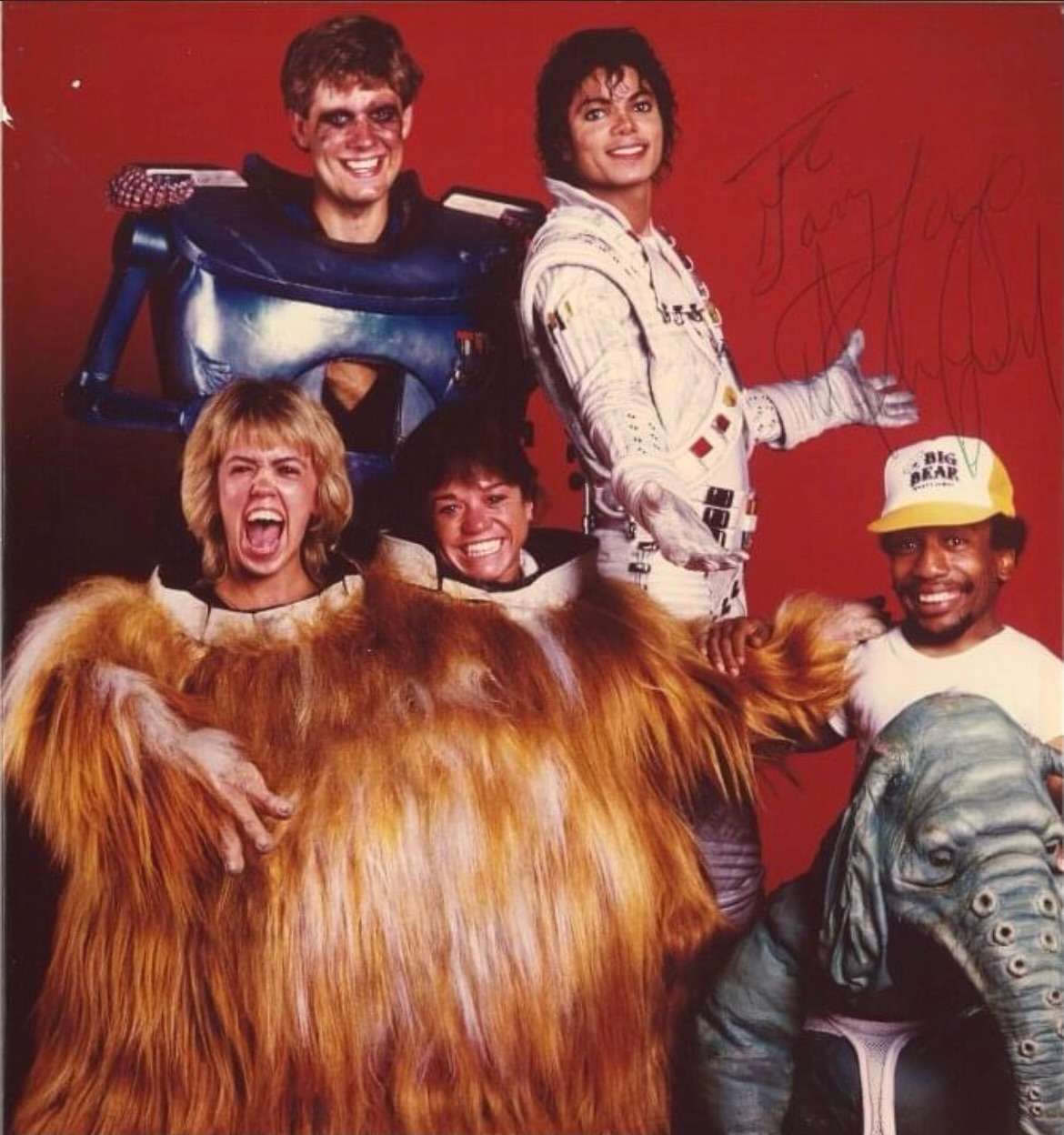 A picture of Gary Depew in his Major Domo costume standing next to Michael Jackson and three other cast members in front of them.